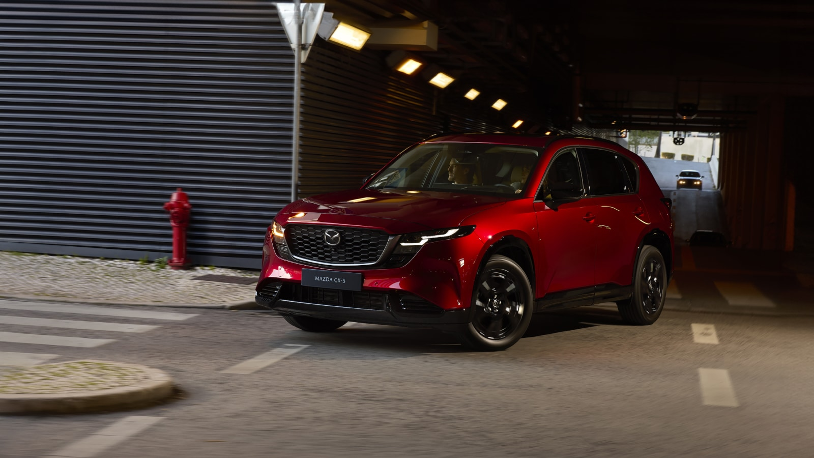 2026 Mazda CX-5 driving out of parking structure
